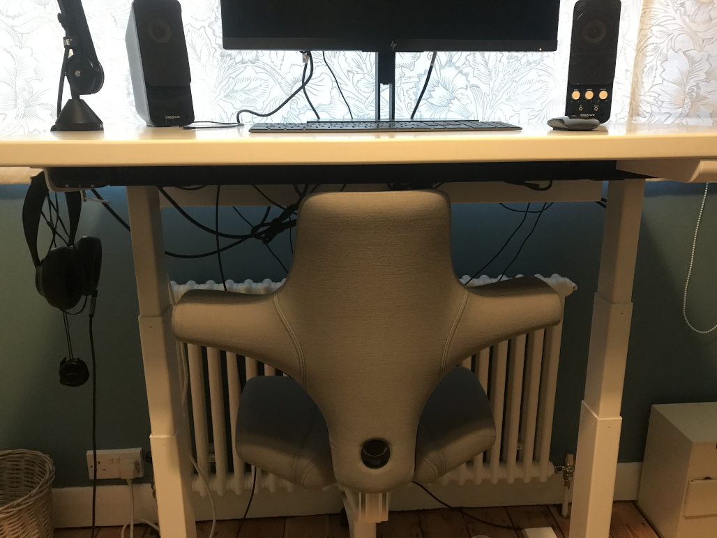 a chair under a standing desk